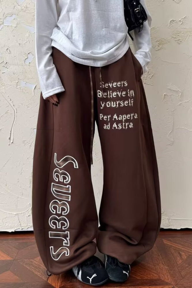 Pantaloni larghi in felpa con motivo a lettere patchwork a quadri