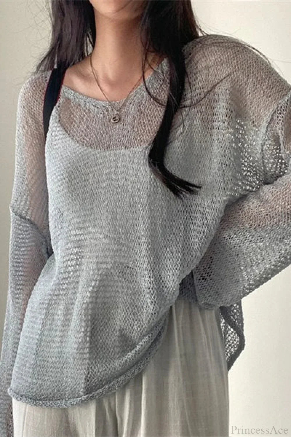 Blusa holgada de manga larga con tejido calado y estilo elegante